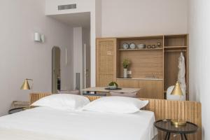 a bedroom with two beds and a kitchen at Palazzo Mulini in Monopoli