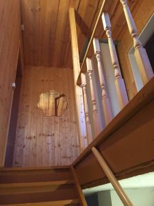 a wooden staircase in a room with a wooden ceiling at Angelhouse studio in Tartu