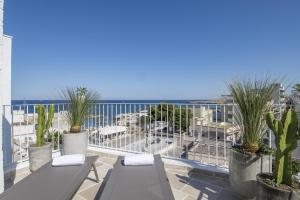 a balcony with two benches and a view of the ocean at Palazzo Mulini in Monopoli