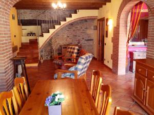 a kitchen and dining room with a table and chairs at Ca L'Estrada in Sant Esteve de Palautordera