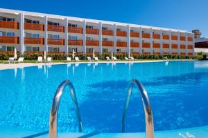 a swimming pool in front of a hotel at Malibu Foz Hotel - La Maison Younan in Figueira da Foz