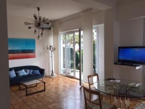 a living room with a glass table and a couch at 91 Promenade des Anglais le stellamar in Nice