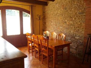 a dining room with a wooden table and chairs at Ca L'Estrada in Sant Esteve de Palautordera +19 photos