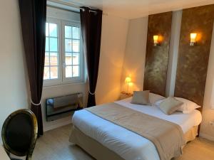 Postel nebo postele na pokoji v ubytování Hôtel de la Plage