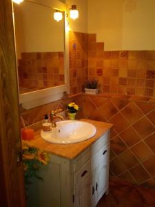 a bathroom with a sink and a tub at Ca L'Estrada in Sant Esteve de Palautordera