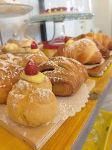 a bunch of pastries sitting on top of a table at B&B L'Officina di Apollo in Mondello
