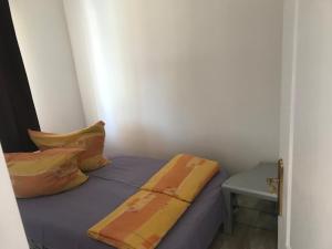 a small bedroom with a bed and a table at Nice Big House in Balatonfenyves +20 photos
