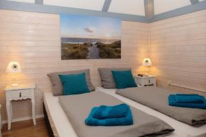 a bedroom with two beds with blue pillows at Ferienhaus Steffi in Kirchheim