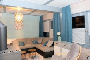 a living room with a couch and a clock on the wall at Ferienhaus Steffi in Kirchheim