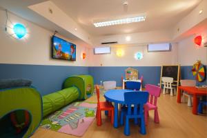 a childrens play room with a table and chairs at Malibu Foz Hotel - La Maison Younan in Figueira da Foz