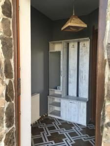 a door into a room with a cabinet and a tile floor at Cottage In Bakuriani in Bakuriani