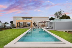 a backyard with a swimming pool and a house at Amaré Chania Luxury Residence in Stérnai