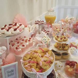 a table with many different pastries and desserts at Hotel Dworek*** in Skierniewice