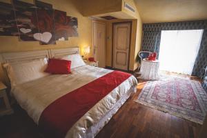 a bedroom with a large bed and a window at Hotel Posta in Cecina