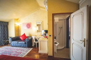 a living room with a couch and a table in a room at Hotel Posta in Cecina