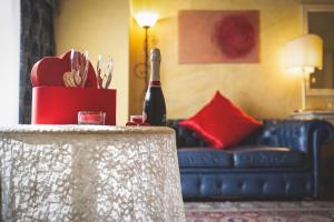 a bottle of wine on a table in a living room at Hotel Posta in Cecina