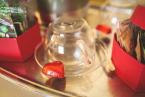 a glass jar with a heart on a table at Hotel Posta in Cecina