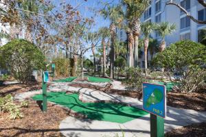 a golf course in a park with trees and a building at Holiday Inn Express & Suites S Lake Buena Vista by IHG in Kissimmee