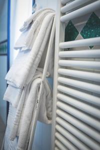 a closet filled with lots of white towels at Hotel Posta in Cecina