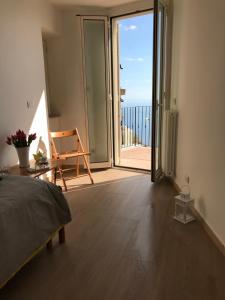 a bedroom with a bed and a view of the ocean at GiorGiada Relax in Castelmola