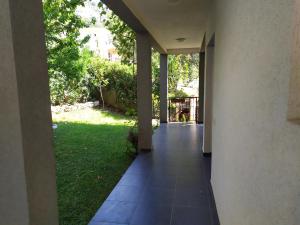 an empty hallway of a house with a green yard at Villa Nadija in Čanj