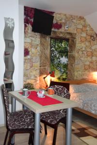 a bedroom with a table with two chairs and a bed at Nadja in Novi Sad