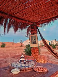 a table with food on it in the desert at Sahara Majestic Luxury Camp in Merzouga