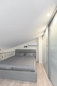 a bedroom with a large bed and a sliding glass door at Kaunas City Center loft by URBAN RENT in Kaunas