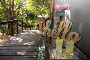 a table with two vases with flowers in them at Camp Bethel in Hoedspruit