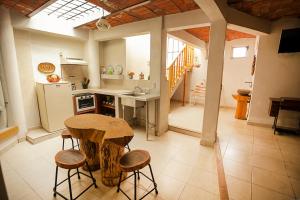 a kitchen with a table and stools in a room at Htl & Villas Las Glorias Mazamitla, céntricas, parking, jardín in Mazamitla +74 photos