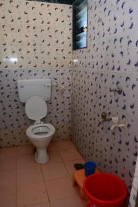 a bathroom with a white toilet in a room at Hotel Sai Sulochana in Shirdi