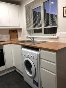 a kitchen with a washing machine and a sink at spacious 2 bedroom house in Shotton +12 photos