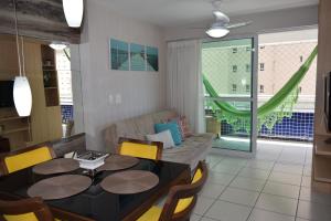 a living room with a table and a couch at Beach Class Exclusive in Fortaleza