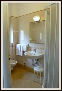 a bathroom with a sink and a mirror at Hotel Del Golfo in Lerici