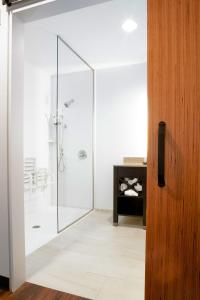 a bathroom with a shower with a glass door at Little Ocmulgee State Park and Lodge in McRae