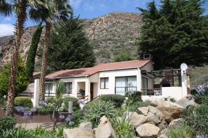 a house with a mountain in the background at Montagu Springs Resort in Montagu