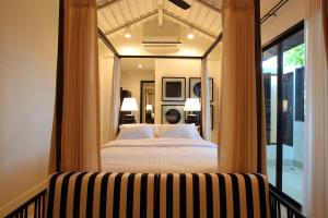 a hotel room with a bed and a window at 99 The Gallery Hotel- SHA Extra Plus in Chiang Mai