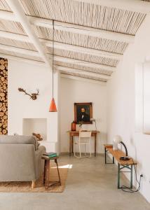 a living room with a couch and a table at Hospedaria in Alvisquer