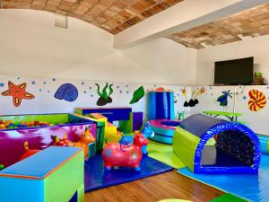 a childrens play room with colorful play equipment at Hospederia Centro de Convenciones Duruelo in Villa de Leyva