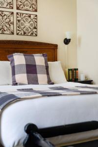 a close up of a bed with a pillow on it at Maison Fleurie, A Four Sisters Inn in Yountville