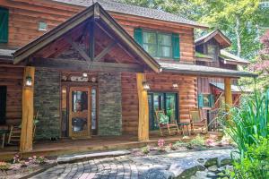 a log cabin with a porch and a patio at Lazy Bear Lodge in Valle Crucis