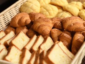 a bunch of pastries and croissants in a basket at APA Hotel Hitachinaka Katsuta Station in Hitachinaka