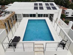 a swimming pool on the roof of a house at Aparta Suites La Flora in Cali