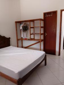 a bedroom with a bed and a ladder and a door at Casa da Família in Nova Viçosa +51 photos