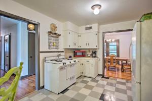 a kitchen with white appliances and a dining room at River District Home with Patio and Yard Pets Welcome! in Fort Worth