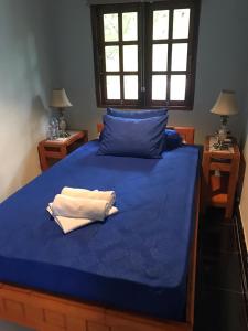 Ένα ή περισσότερα κρεβάτια σε δωμάτιο στο Mangga Lodge