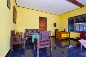 een kamer met stoelen, een tafel en een bureau bij SPOT ON 2821 Griya Kawula Syariah in Solo