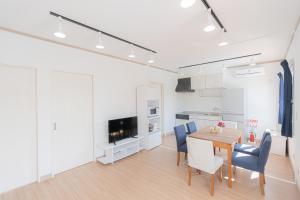 a kitchen and dining room with a table and chairs at Regina Ishigaki in Ishigaki Island