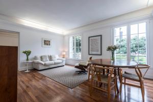 a living room with a table and a couch at Manor House Lima in Lima