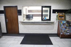 a store front with a window with a sign on it at Super 8 by Wyndham Richmond Airport VA in Richmond +23 photos